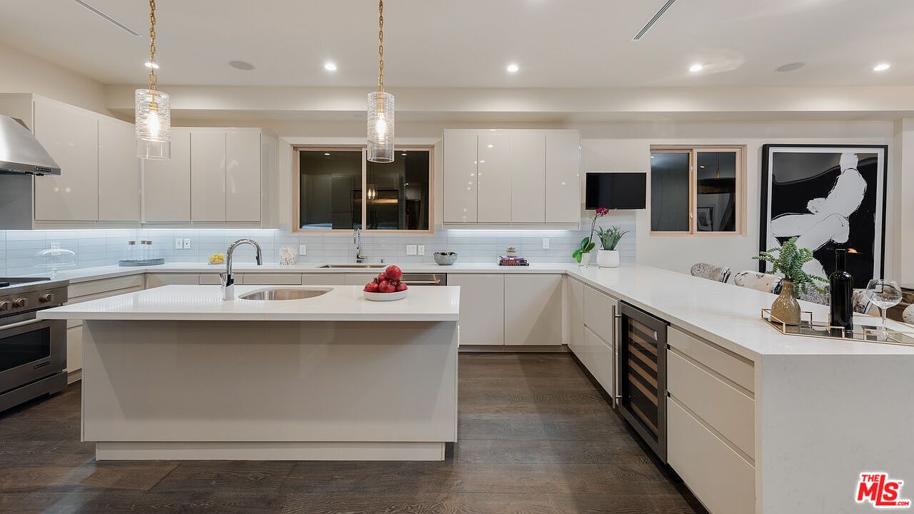 2408 Castle Heights Avenue Los Angeles, CA 90034 - Photo 13 of 28 a kitchen with kitchen island a sink stainless steel appliances and cabinets