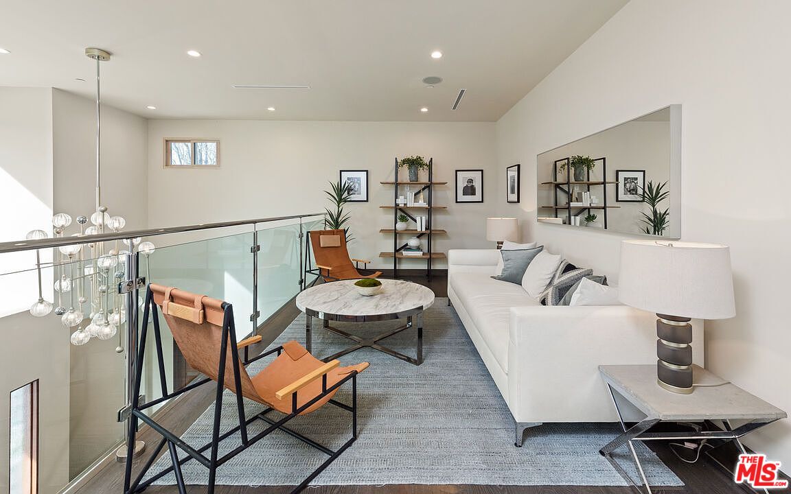 2408 Castle Heights Avenue Los Angeles, CA 90034 - Photo 15 of 28 a living room with furniture and a wooden floor