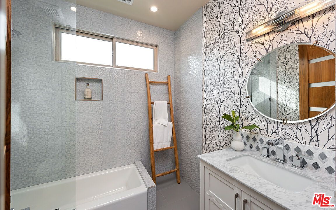 2408 Castle Heights Avenue Los Angeles, CA 90034 - Photo 17 of 28 a bathroom with a sink and a mirror