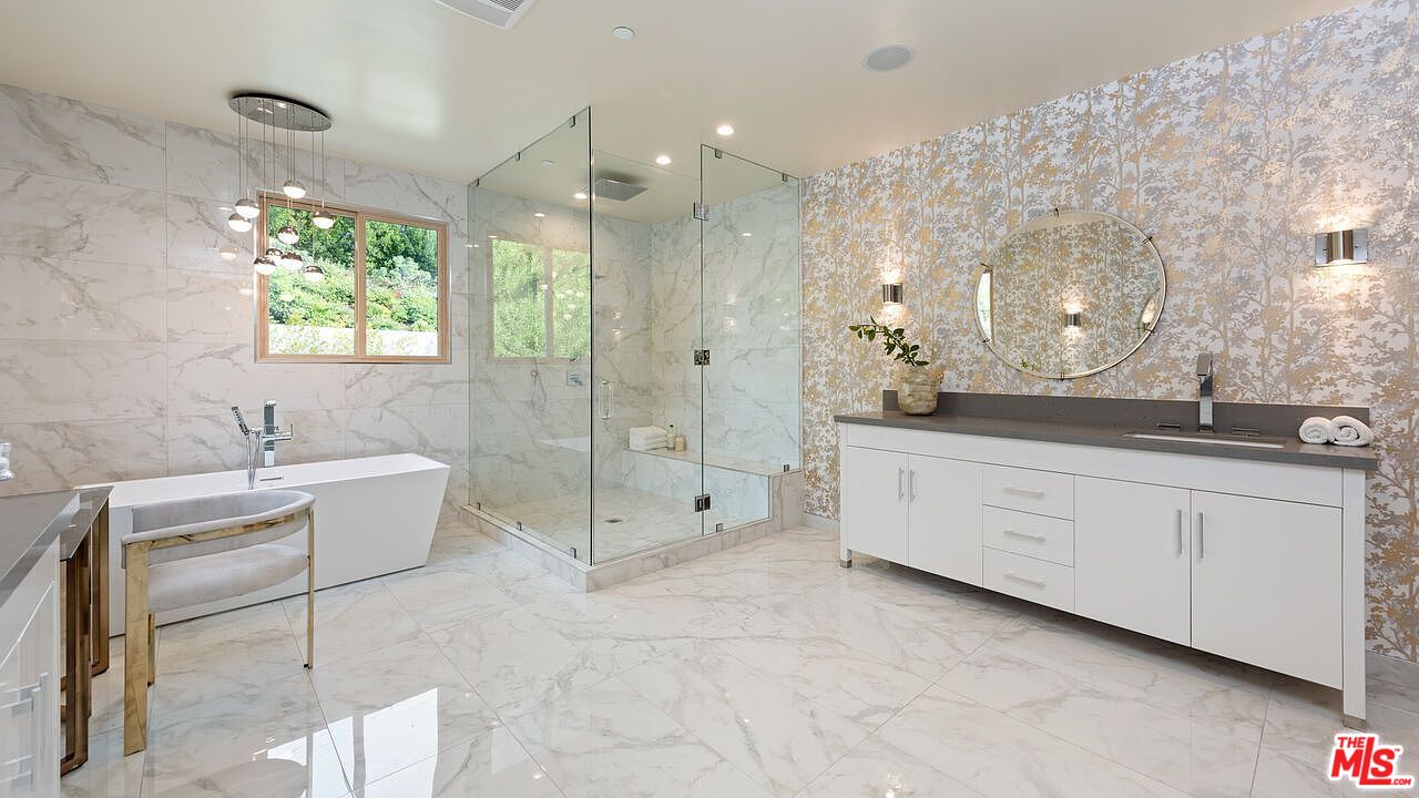 2408 Castle Heights Avenue Los Angeles, CA 90034 - Photo 21 of 28 a spacious bathroom with a granite countertop sink a toilet a mirror and shower