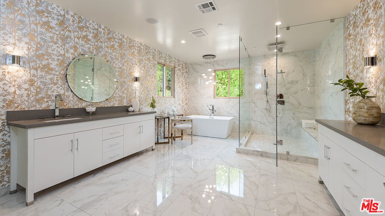 2408 Castle Heights Avenue Los Angeles, CA 90034 - Photo 23 of 28 a spacious bathroom with a double vanity sink a large mirror and shower
