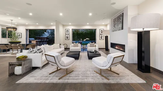 a living room with fireplace furniture and a flat screen tv