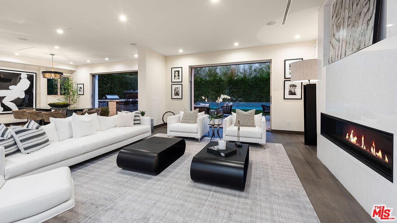 2408 Castle Heights Avenue Los Angeles, CA 90034 - Photo 9 of 28 a living room with furniture fireplace and a flat screen tv