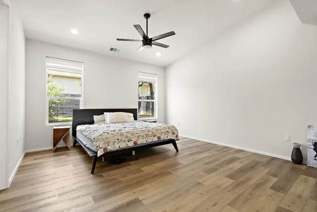 a bedroom with a bed window and a table