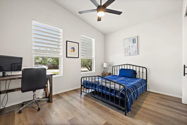 a bedroom with a bed and a desk