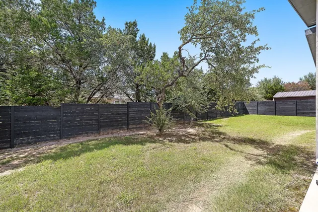 a view of a backyard with a tree