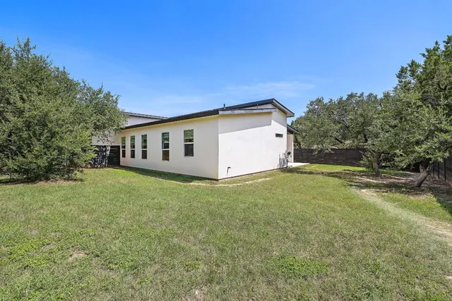 a view of a backyard with large trees