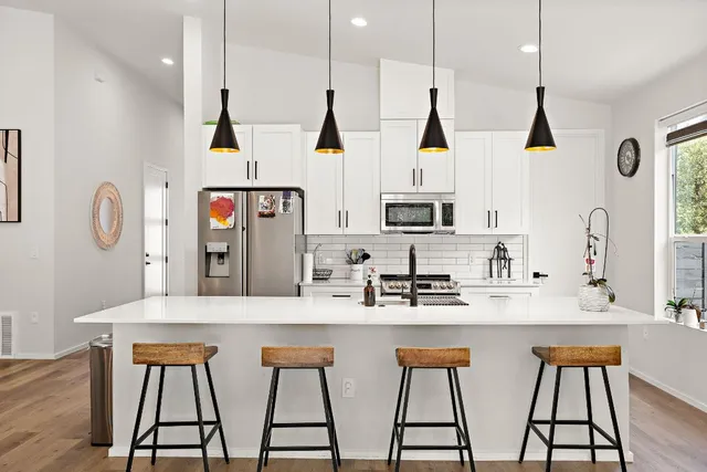 a kitchen with stainless steel appliances kitchen island a refrigerator and a stove