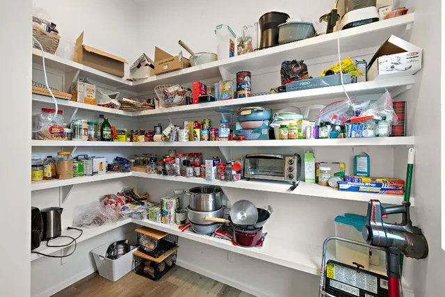 a room with a wooden floor and shelf