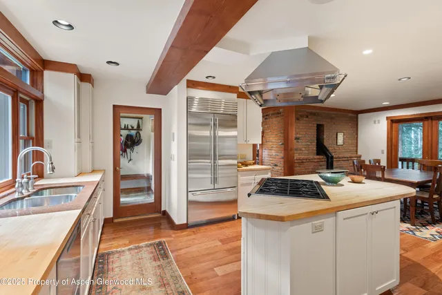 a kitchen that has a sink stainless steel appliances a counter space and a window