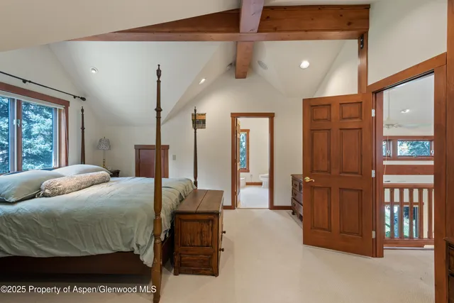 a bedroom with a bed closet and a large mirror