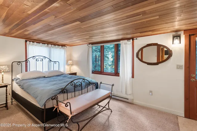 a bedroom with a bed next to a window