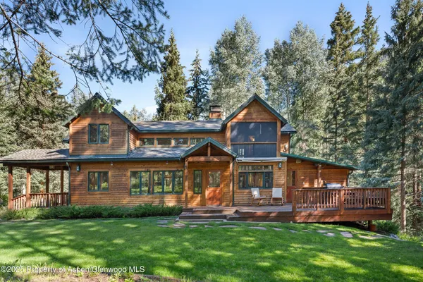 a front view of a house with a garden and deck