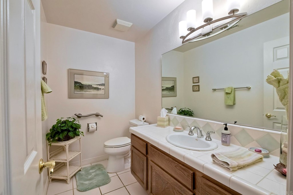 2270 Valley Road Oceanside, CA 92056 - Photo 21 of 37 a bathroom with a granite countertop sink mirror and toilet