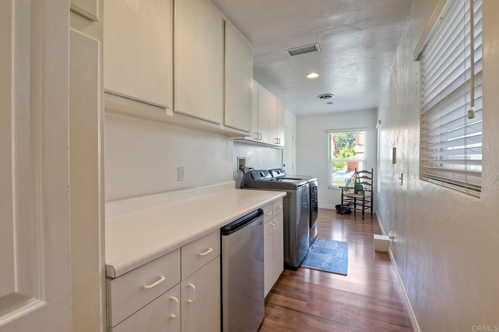 2270 Valley Road Oceanside, CA 92056 - Photo 22 of 37 a kitchen with cabinets and wooden floor