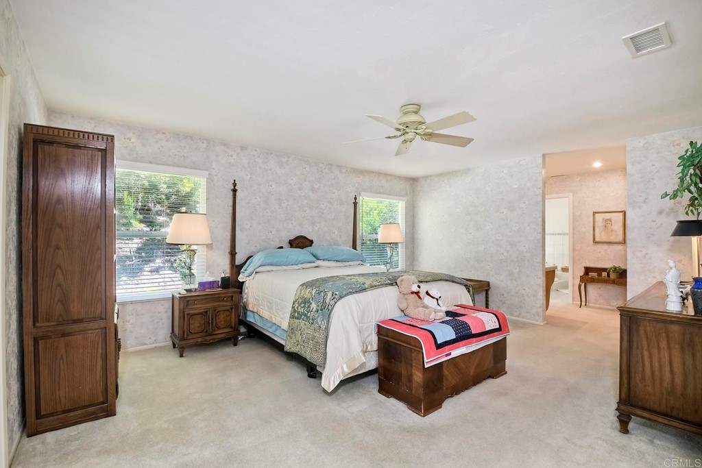 2270 Valley Road Oceanside, CA 92056 - Photo 24 of 37 a spacious bedroom with a bed and a chandelier