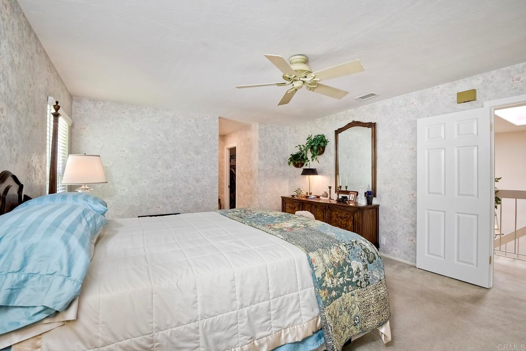 2270 Valley Road Oceanside, CA 92056 - Photo 25 of 37 a bedroom with a bed and a chandelier