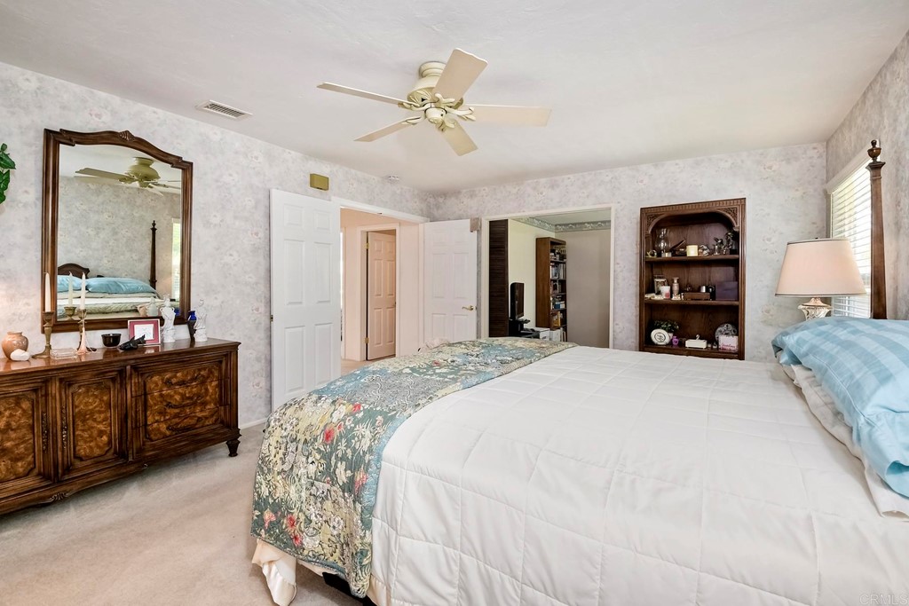 2270 Valley Road Oceanside, CA 92056 - Photo 27 of 37 a spacious bedroom with a large bed and a flat tv screen