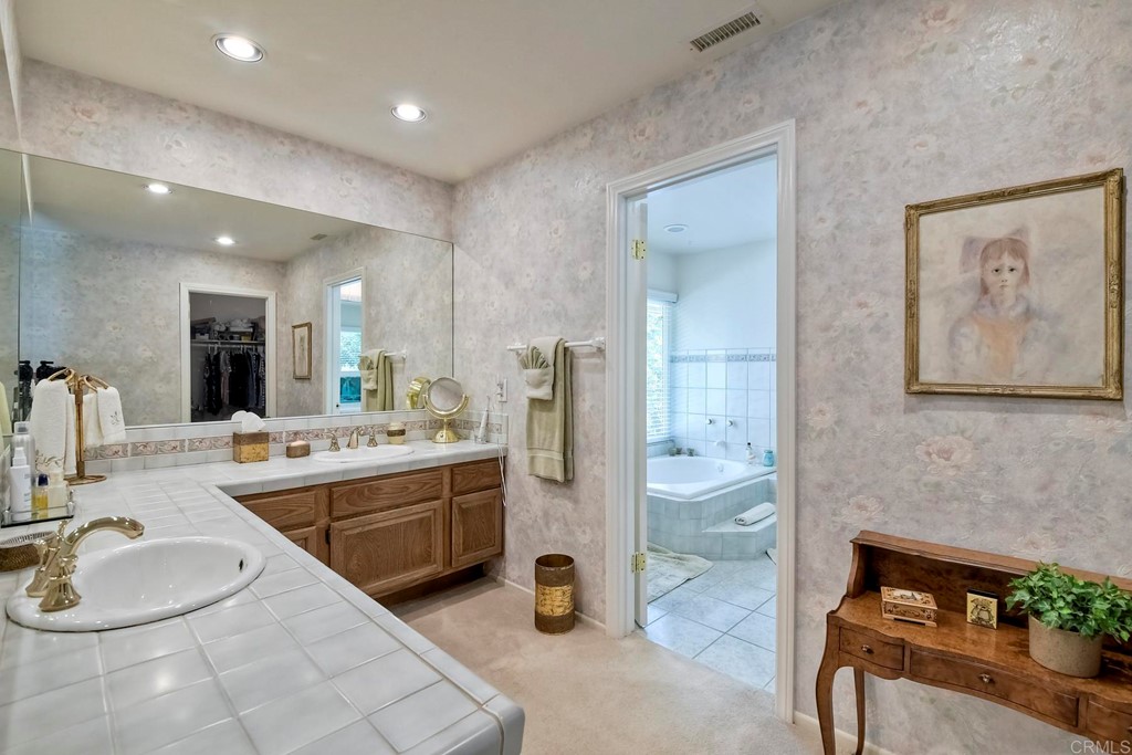 2270 Valley Road Oceanside, CA 92056 - Photo 28 of 37 a bathroom with a tub sink and mirror