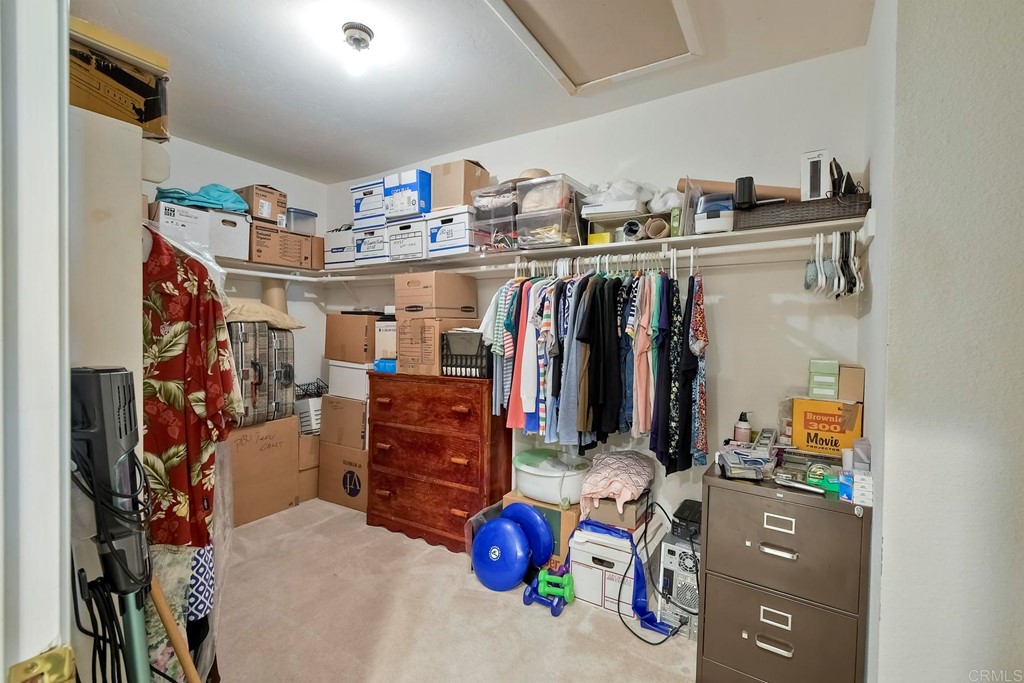 2270 Valley Road Oceanside, CA 92056 - Photo 30 of 37 a view of walk in closet with clothes and shoes
