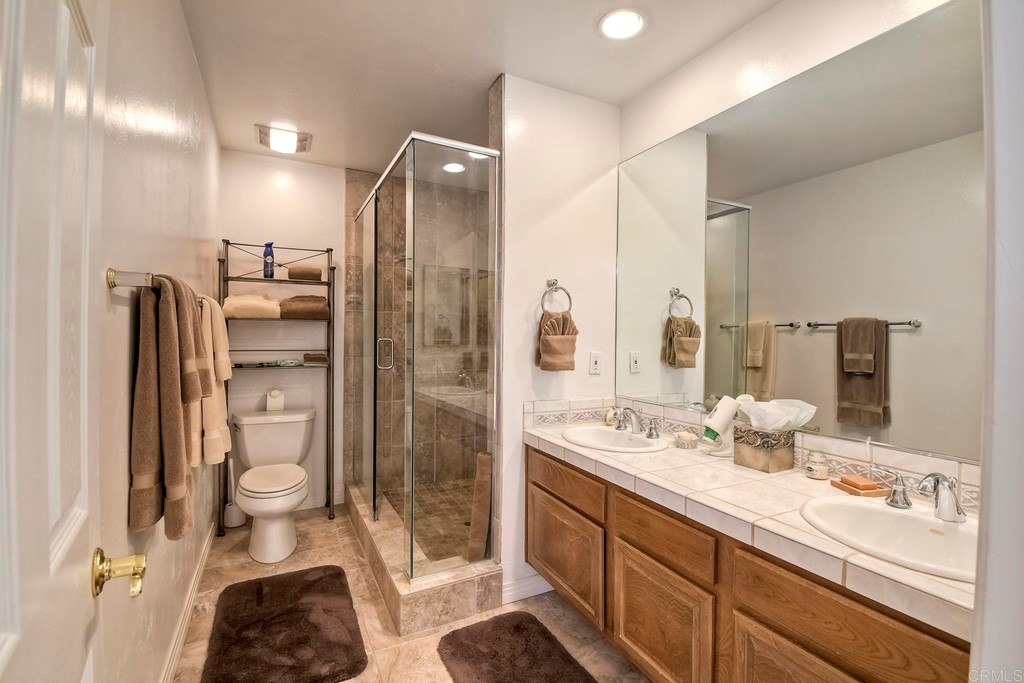 2270 Valley Road Oceanside, CA 92056 - Photo 32 of 37 a bathroom with a double vanity sink mirror and shower
