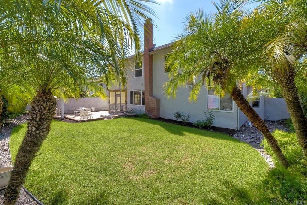 2270 Valley Road Oceanside, CA 92056 - Photo 35 of 37 a backyard of a house with table and chairs under an umbrella