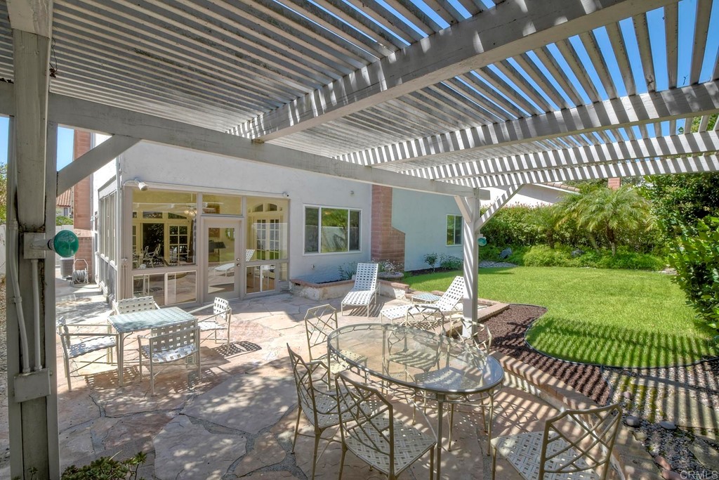 2270 Valley Road Oceanside, CA 92056 - Photo 37 of 37 a view of a patio with table and chairs with wooden floor and fence