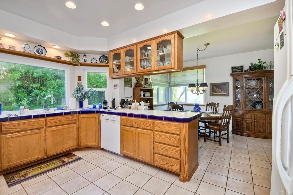 2270 Valley Road Oceanside, CA 92056 - Photo 6 of 37 a kitchen with stainless steel appliances granite countertop a refrigerator and a sink