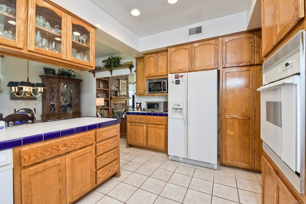 2270 Valley Road Oceanside, CA 92056 - Photo 8 of 37 a kitchen with stainless steel appliances a refrigerator sink and cabinets