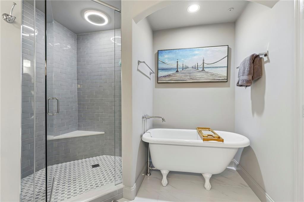 3445 Stratford Road Northeast, Unit 3105 Atlanta, GA 30326 - Photo 23 of 47 a bathroom with a bathtub and shower