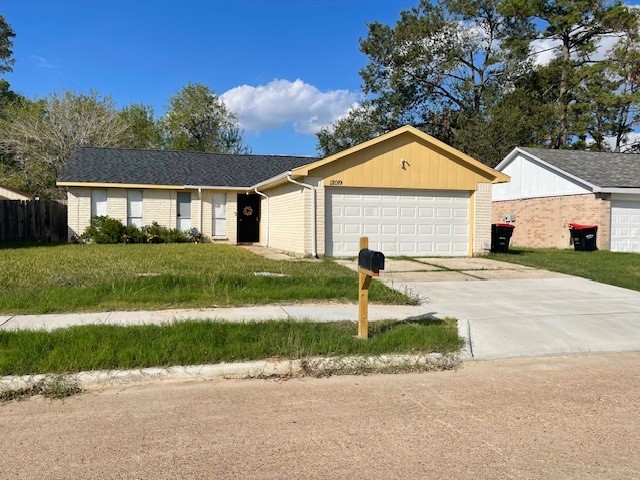 a front view of a house with a garden and yard