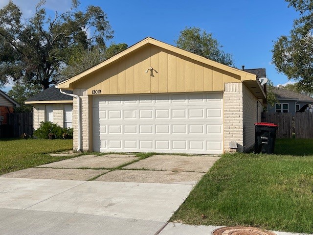 12019 Kings Grove Drive Houston, TX 77044 - Photo 2 of 50 a front view of a house with a yard and garage