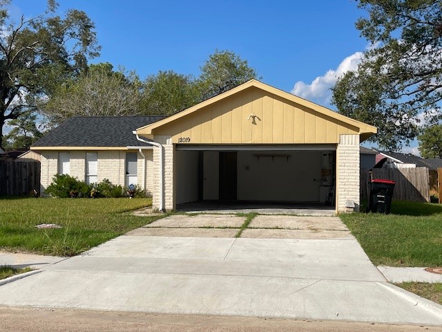 12019 Kings Grove Drive Houston, TX 77044 - Photo 21 of 50 a front view of a house with a yard and garage