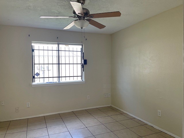 12019 Kings Grove Drive Houston, TX 77044 - Photo 24 of 50 an empty room with a window and a fan