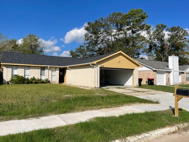 12019 Kings Grove Drive Houston, TX 77044 - Photo 38 of 50 a front view of a house with a yard and garage