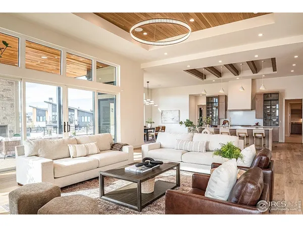 a living room with furniture a rug and a large window