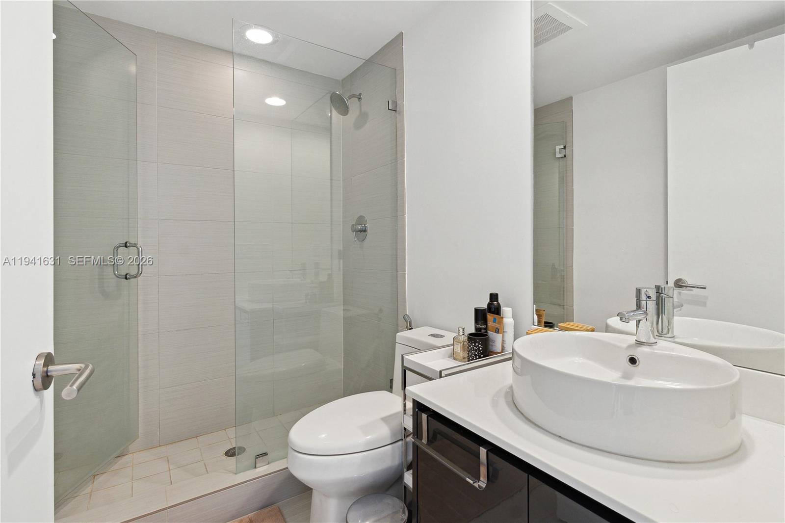 31 Southeast 6th Street, Unit 2007 Miami, FL 33131 - Photo 14 of 22 a bathroom with a sink toilet and shower