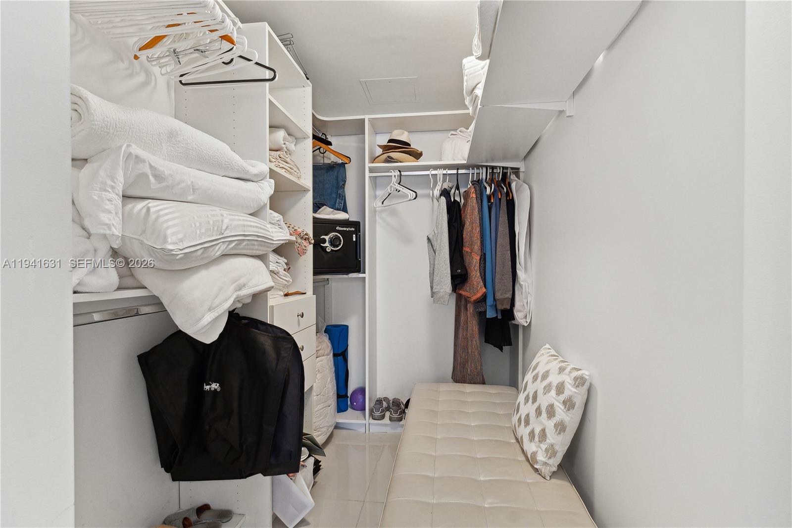 31 Southeast 6th Street, Unit 2007 Miami, FL 33131 - Photo 15 of 22 a view of walk in closet with clothes and shoes