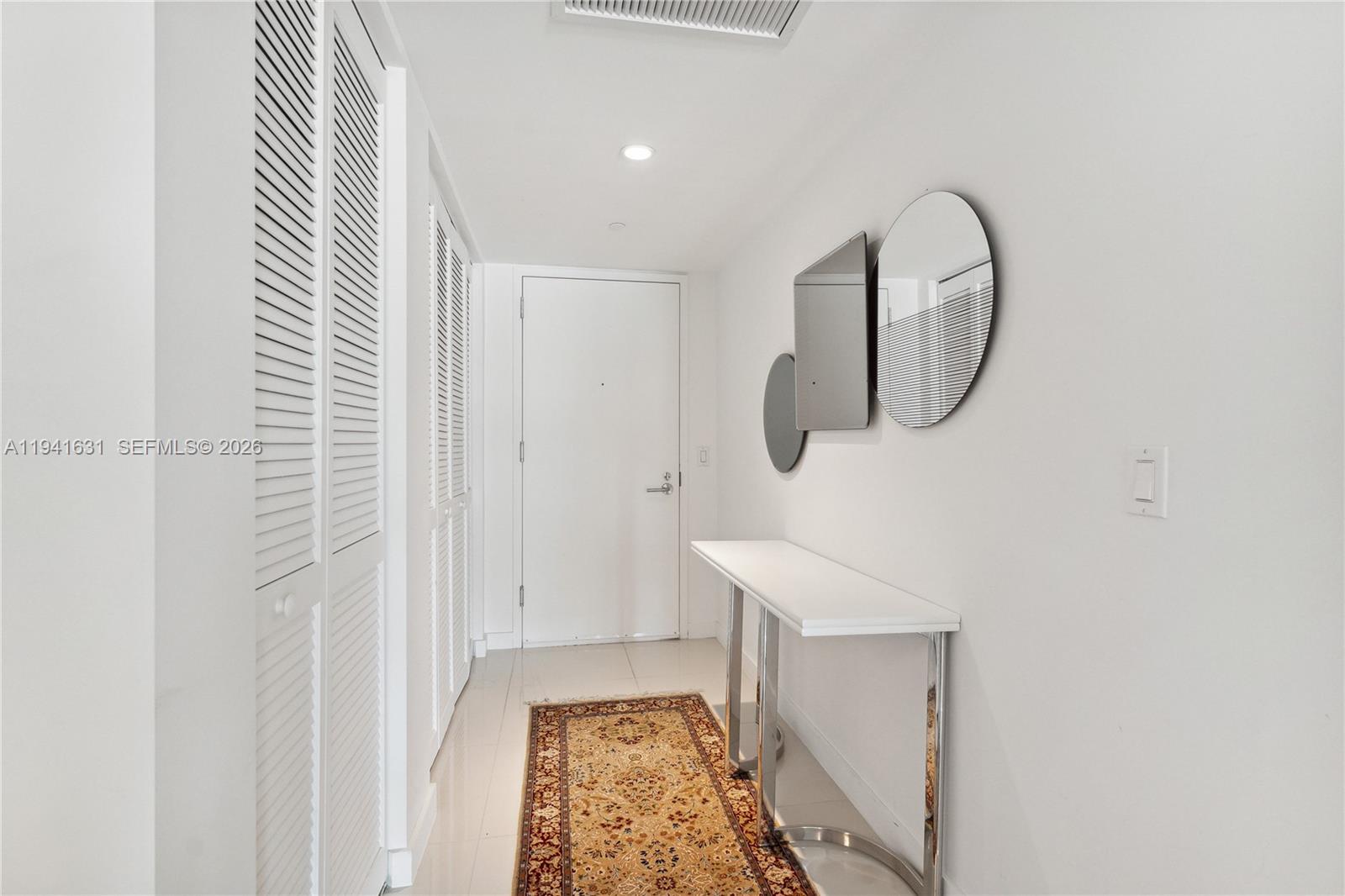 31 Southeast 6th Street, Unit 2007 Miami, FL 33131 - Photo 2 of 22 a front view of a house with wooden floor and a white wall