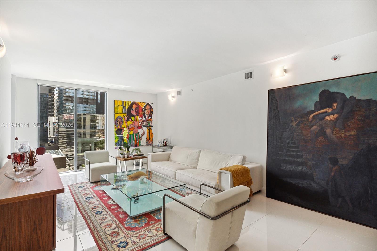 31 Southeast 6th Street, Unit 2007 Miami, FL 33131 - Photo 5 of 22 a living room with furniture and a flat screen tv