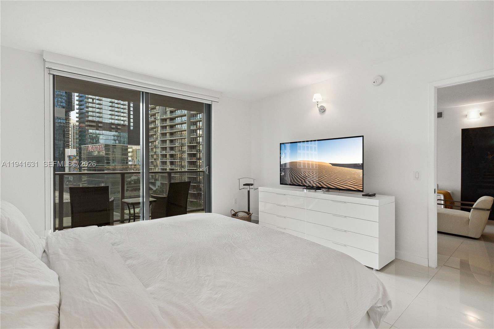 31 Southeast 6th Street, Unit 2007 Miami, FL 33131 - Photo 10 of 22 a room with a bed and a flat screen tv