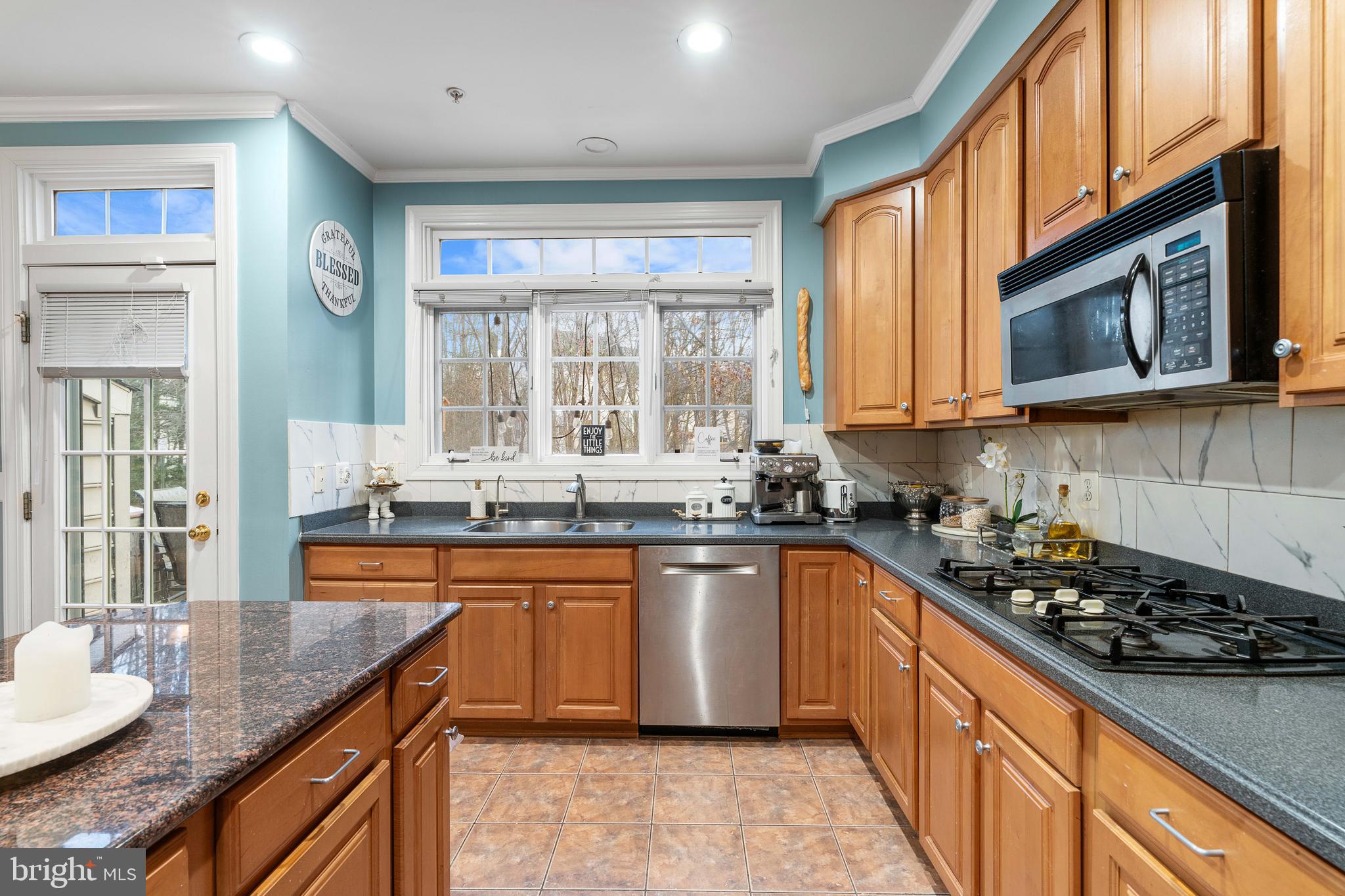 12461 Rose Path Circle Fairfax, VA 22033 - Photo 13 of 43 a kitchen with stainless steel appliances granite countertop a sink stove and cabinets