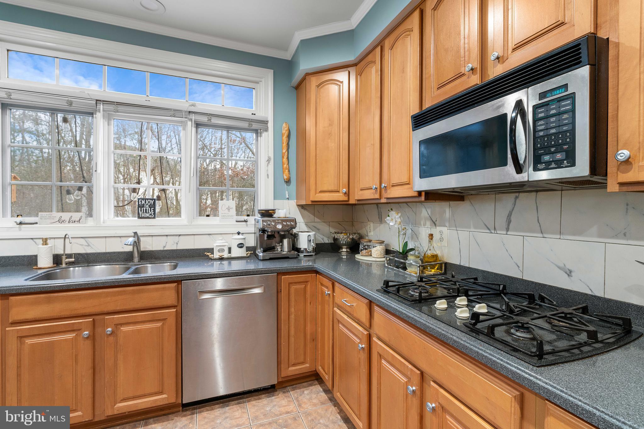 12461 Rose Path Circle Fairfax, VA 22033 - Photo 15 of 43 a kitchen with stainless steel appliances a sink a stove and cabinets