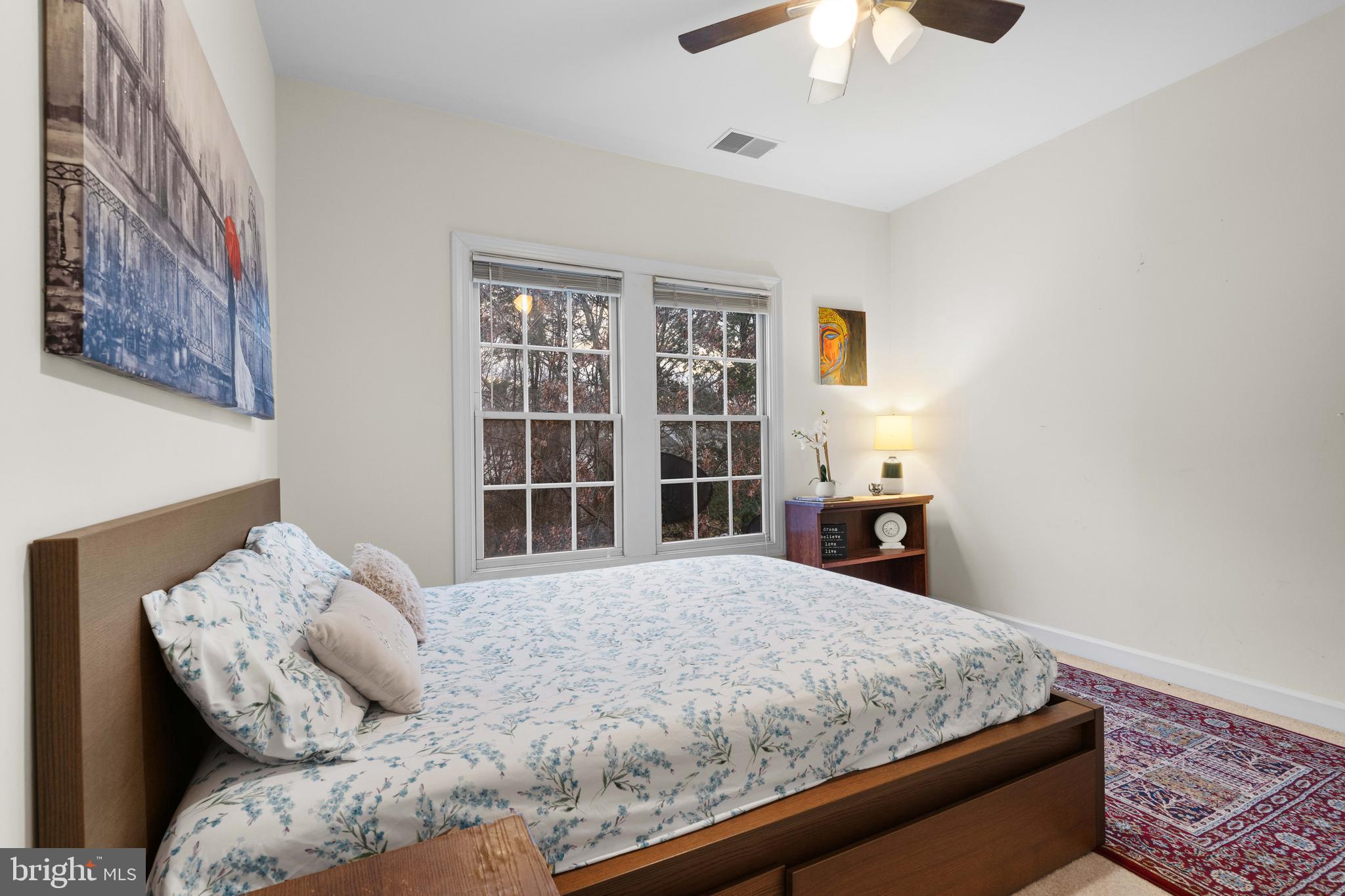 12461 Rose Path Circle Fairfax, VA 22033 - Photo 23 of 43 a large bed sitting in a bedroom next to a lamp and a chandelier