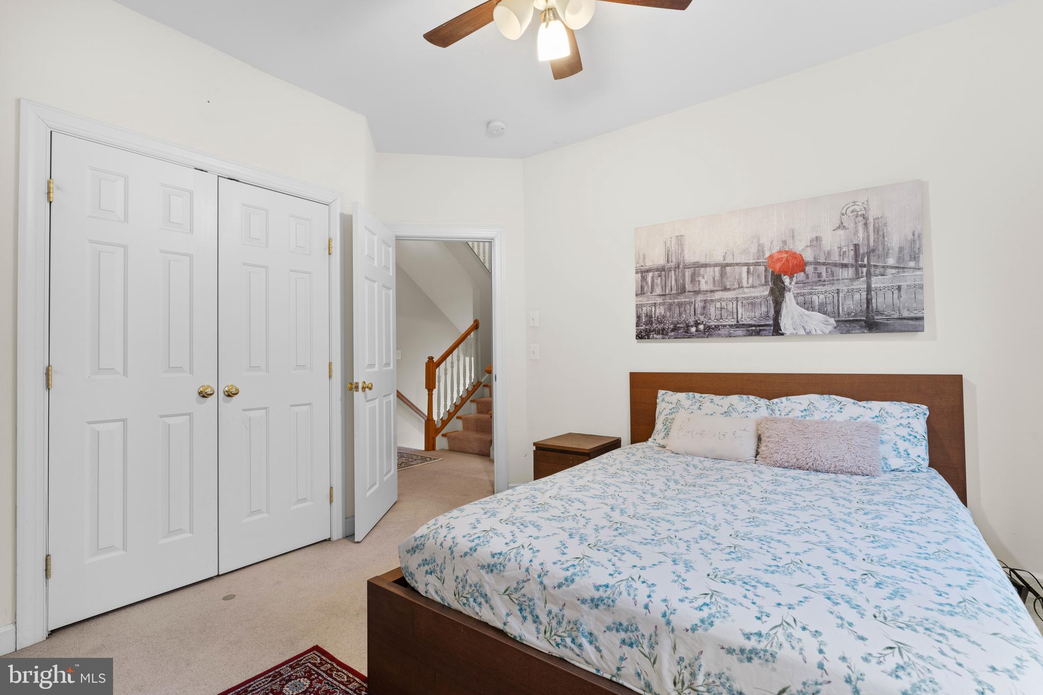 12461 Rose Path Circle Fairfax, VA 22033 - Photo 26 of 43 a bedroom with a bed and a chandelier