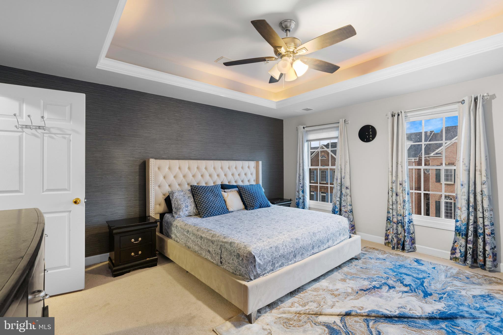 12461 Rose Path Circle Fairfax, VA 22033 - Photo 6 of 43 a bedroom with a large bed and a chandelier