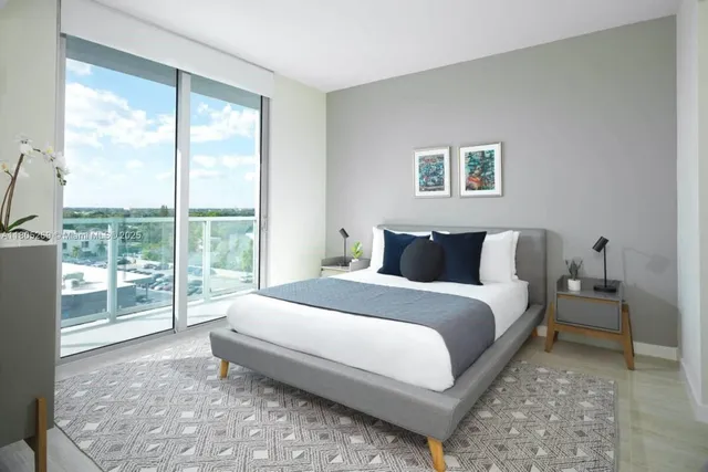 a spacious bedroom with a bed and a large window