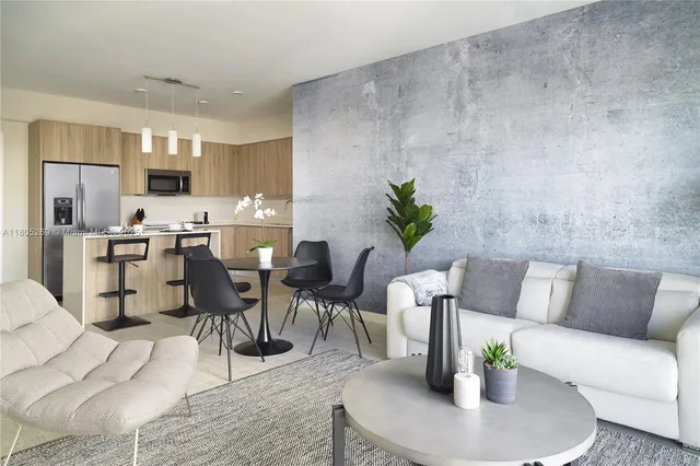 a living room with furniture kitchen view and a dining table
