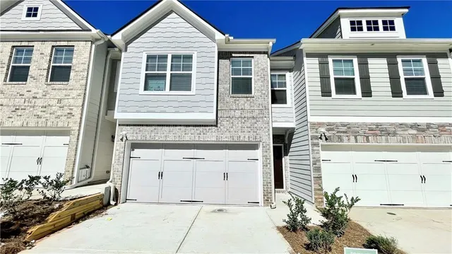 a view of a brick house with large windows