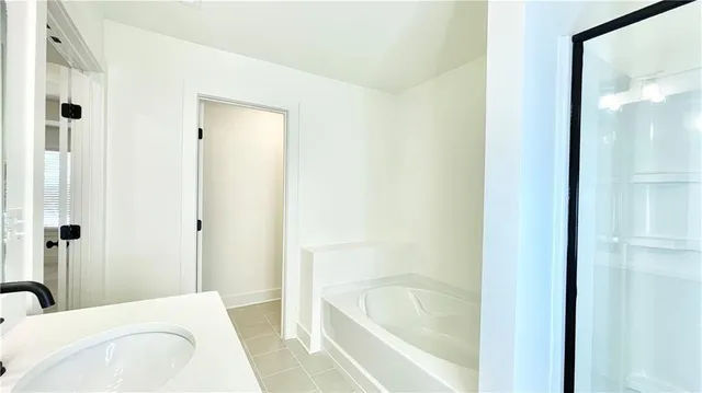 a bathroom with a sink a mirror and a shower